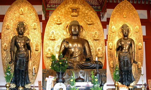 Three statues of a Yakushi Nyorai(Tathāgata) and two Bodhisattvas in Yakushi-ji( Temple), Nara: a bronze casting in the early 8th century
